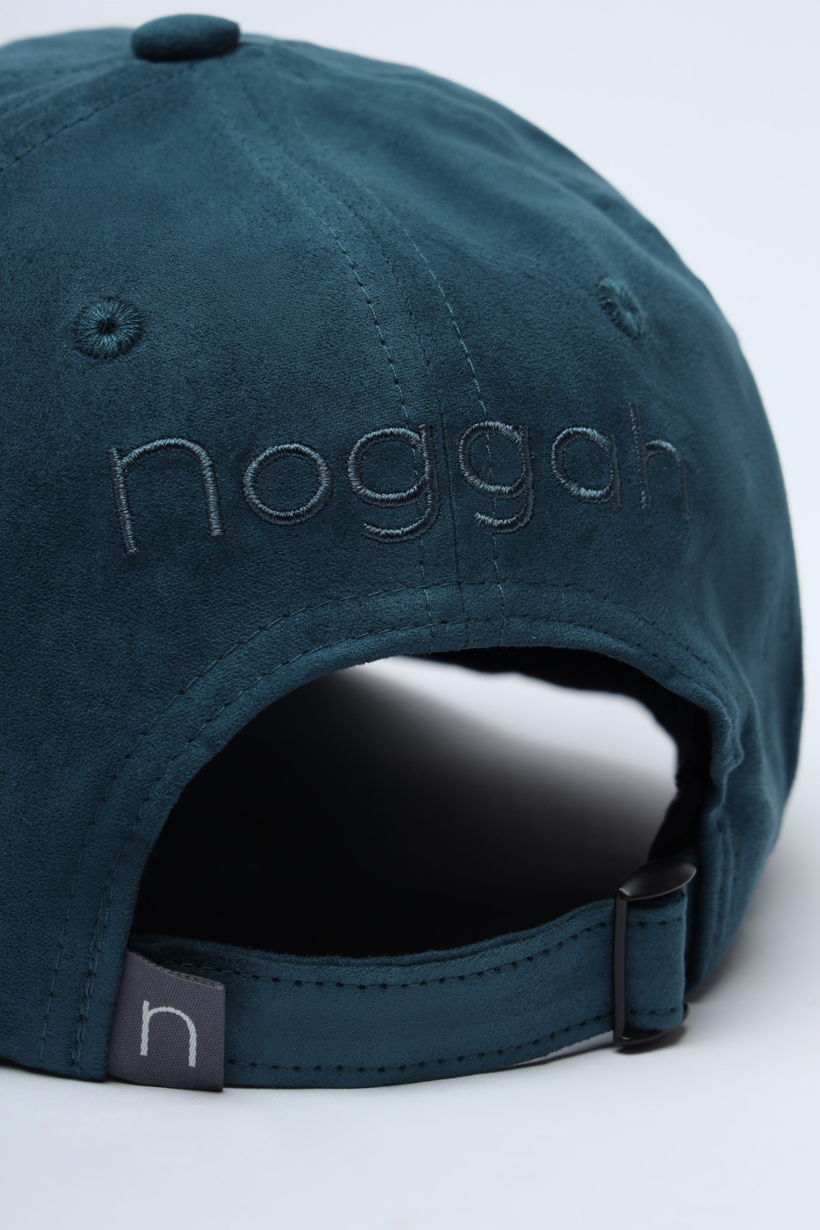 Unisex bottle green cap with curved brim and soft suede finish
