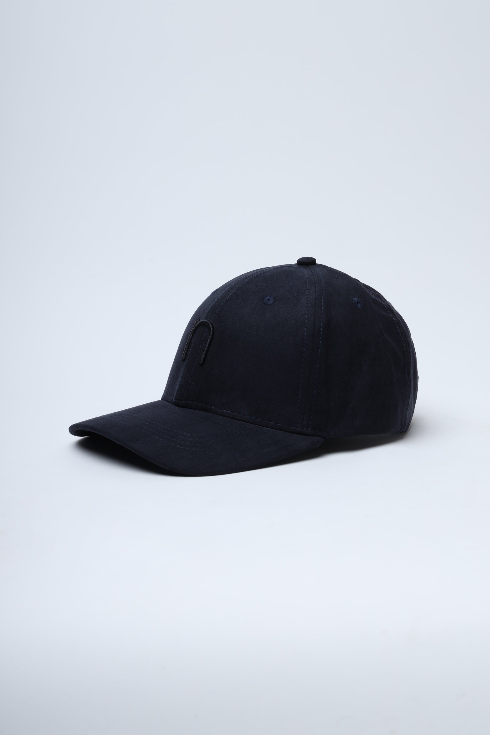 Close-up of NDC005 teal blue cap highlighting soft suede texture and logo detail