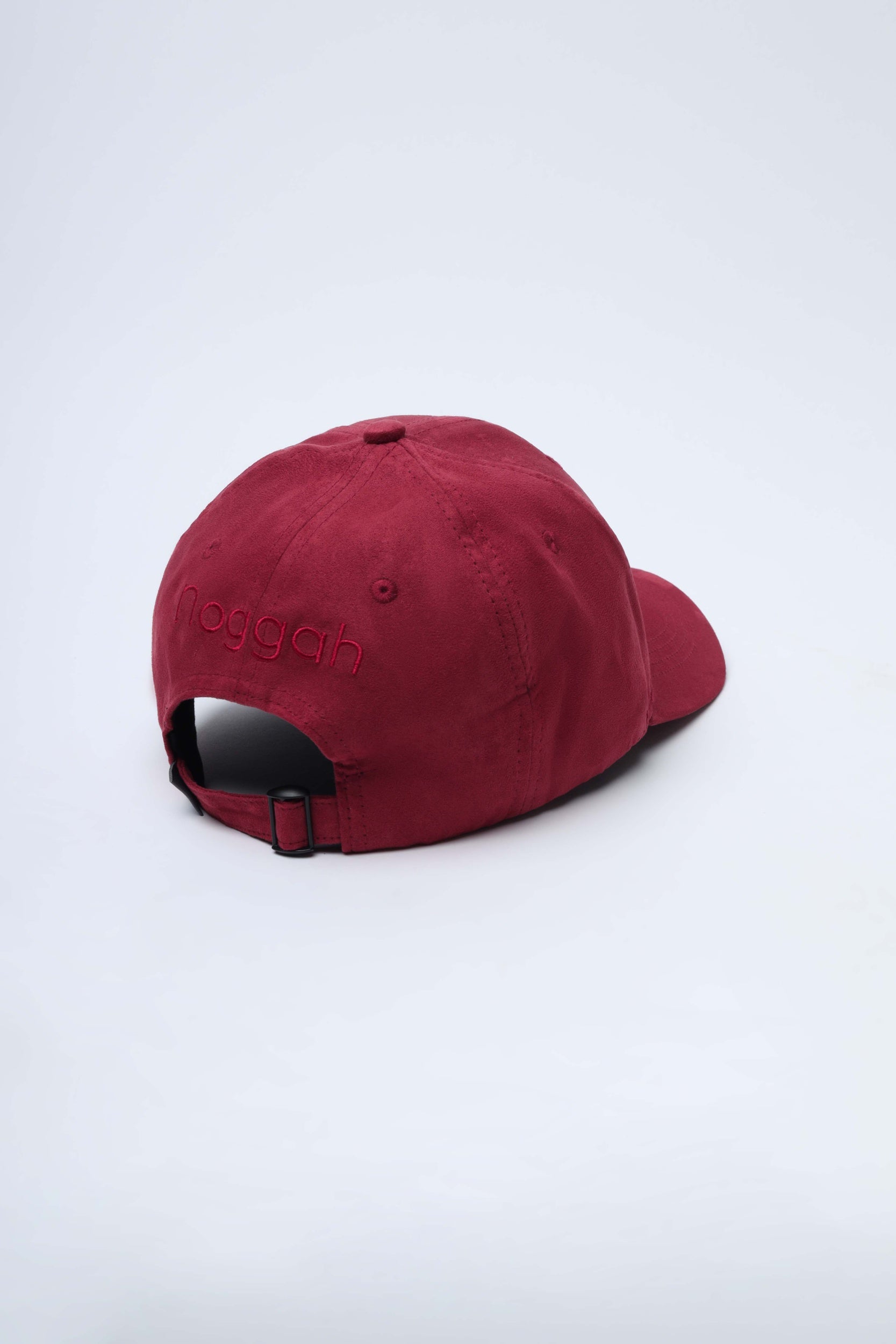 Close-up of NDC007 Sunset Rush cap showing bold suede color and stitching details